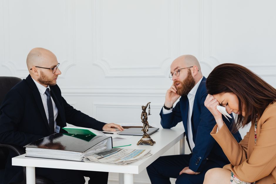 Discussion sérieuse entre professionnels dans un bureau avec des documents juridiques.